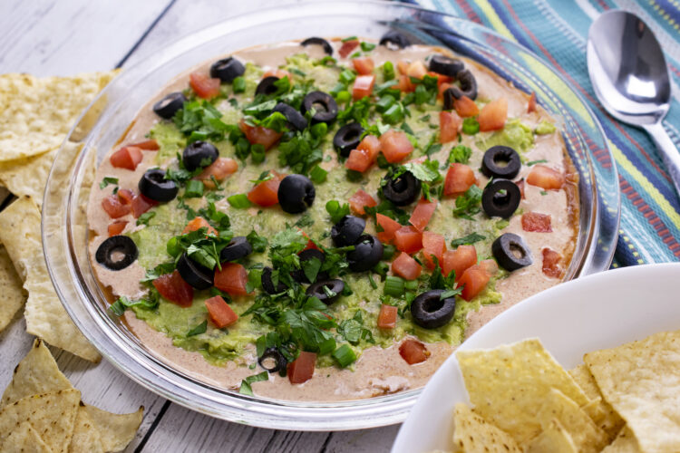 Bring fans, friends together with this healthy 7-layer taco dip with refried beans